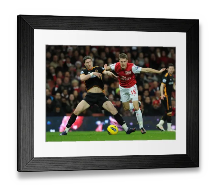 Framed Print : Ramsey vs. Ward: Intense Clash Between Arsenal's Aaron Ramsey and Wolverhampton Wanderers Stephen Ward in Premier League Match Framed Print : Ramsey vs. Ward: Intense Clash Between Arsenal's Aaron Ramsey and Wolverhampton Wanderers Stephen Ward in Premier League Match