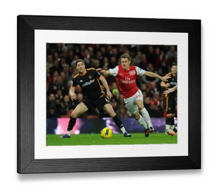 Framed Print : Arsenal's Aaron Ramsey vs. Wolves Stephen Ward: A Football Rivalry Erupts on the Pitch