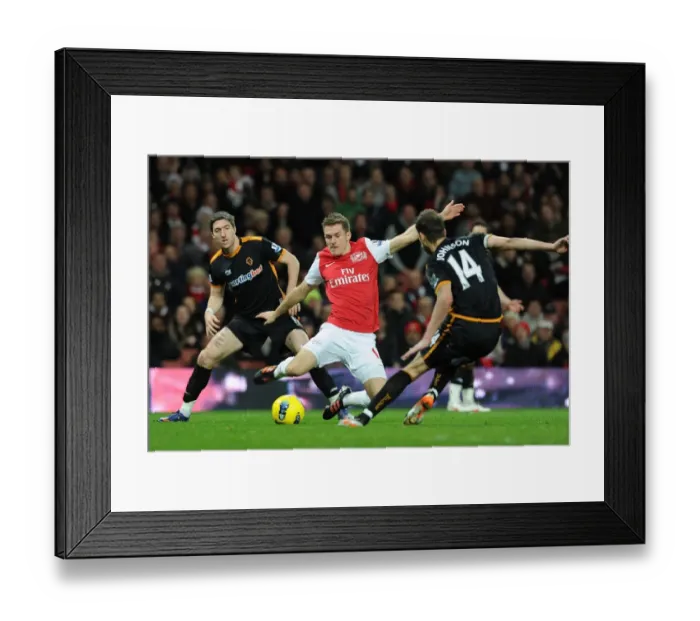 Framed Print : Arsenal's Aaron Rasmey Surges Past Wolves Stephen Ward and Roger Johnson