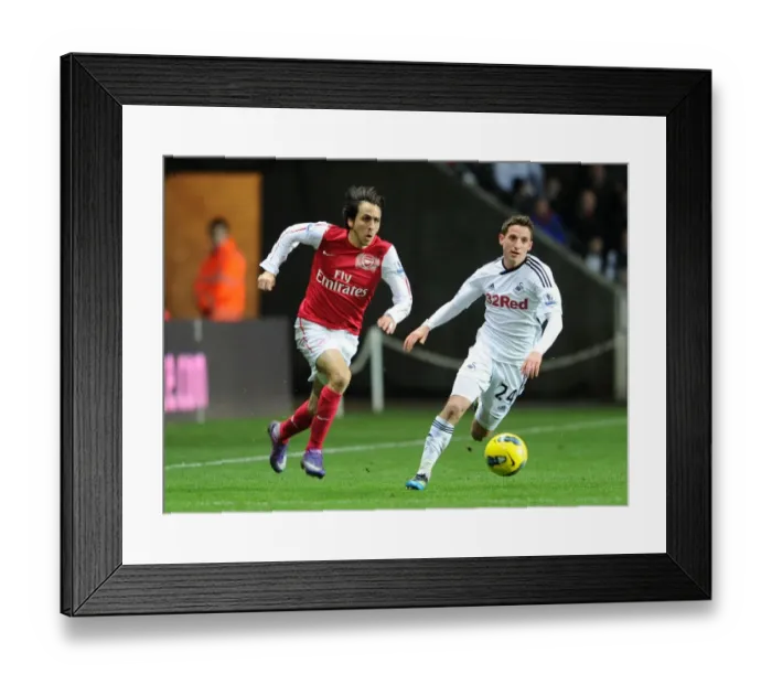Framed Print : Clash of Midfield Maestros: Yossi Benayoun vs Joe Allen (Swansea City vs Arsenal, 2012) Framed Print : Clash of Midfield Maestros: Yossi Benayoun vs Joe Allen (Swansea City vs Arsenal, 2012)