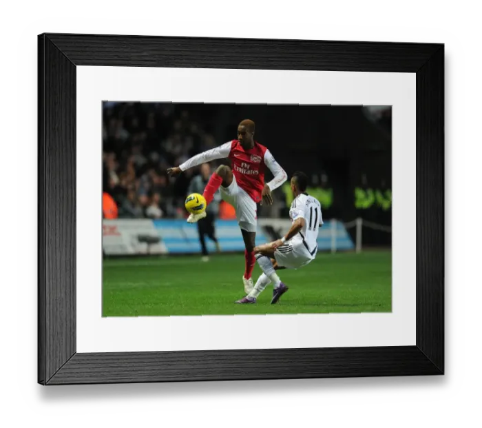 Framed Print : Johan Djourou vs. Scott Sinclair: A Battle in the Premier League Between Swansea City and Arsenal