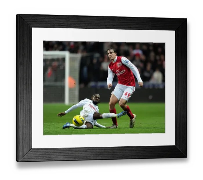 Framed Print : Miquel Leaps Past Dyer: Swansea vs Arsenal, Premier League Clash (2011-2012) Framed Print : Miquel Leaps Past Dyer: Swansea vs Arsenal, Premier League Clash (2011-2012)