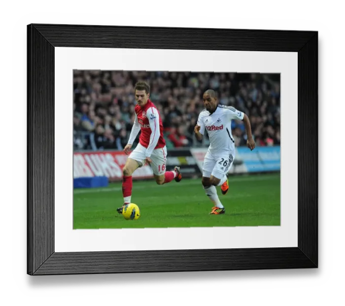 Framed Print : Clash of Midfielders: Ramsey vs. Agustien - Swansea City vs. Arsenal, Premier League, 2012