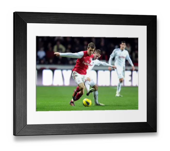 Framed Print : Arsenal's Aaron Ramsey Fends Off Gylfi Sigurdsson's Challenge During Swansea Clash Framed Print : Arsenal's Aaron Ramsey Fends Off Gylfi Sigurdsson's Challenge During Swansea Clash