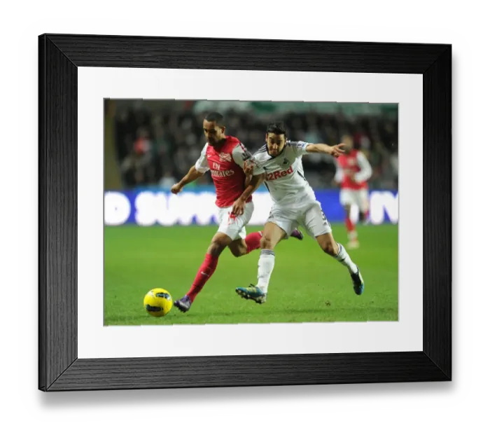 Framed Print : Theo Walcott vs Neil Taylor: Intense Battle in Swansea City vs Arsenal Premier League Clash Framed Print : Theo Walcott vs Neil Taylor: Intense Battle in Swansea City vs Arsenal Premier League Clash