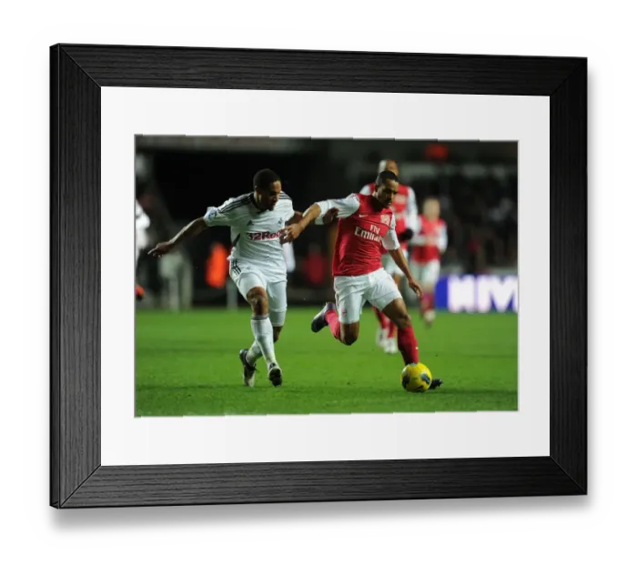 Framed Print : Theo Walcott vs Ashley Williams: Intense Battle in Swansea City vs Arsenal (2011-12) Framed Print : Theo Walcott vs Ashley Williams: Intense Battle in Swansea City vs Arsenal (2011-12)