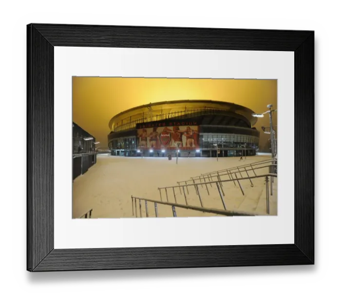 Framed Print : Winter's Battle at Emirates: Arsenal vs. Blackburn Rovers Amidst a Snow-Covered Stadium
