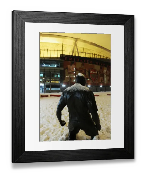 Framed Print : Winter's Battle at Emirates: Arsenal vs. Blackburn Rovers Amidst a Snow-Covered Stadium