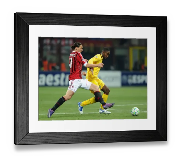 Framed Print : Clash of Titans: Johan Djourou vs Zlatan Ibrahimovic - AC Milan vs Arsenal FC, UEFA Champions League 2012
