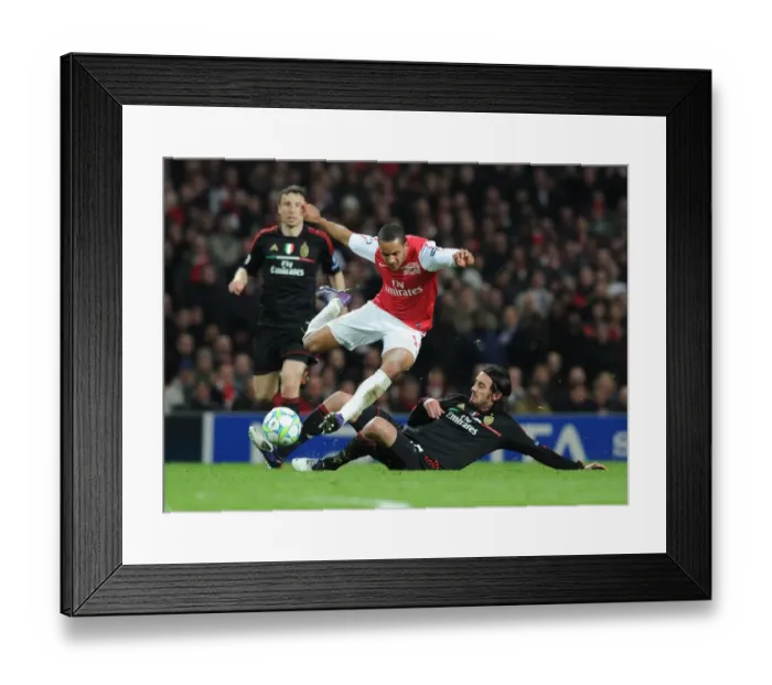 Framed Print : Theo Walcott vs Alberto Aquilani: Intense Battle in Arsenal FC vs AC Milan UEFA Champions League Clash Framed Print : Theo Walcott vs Alberto Aquilani: Intense Battle in Arsenal FC vs AC Milan UEFA Champions League Clash