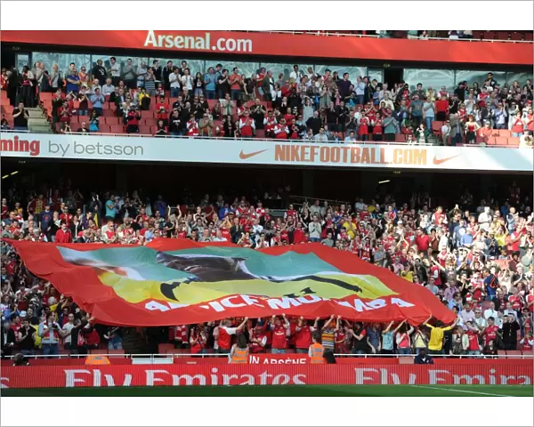 Arsenal fans with a banner to support former player Fabrice Muamba who collapsed whilst playing for Bolton. Arsenal 3: 0 Aston Villa. Barclays Premier League. Emirates Stadium, 24  /  3  /  12. Credit : Arsenal Football Club  / 