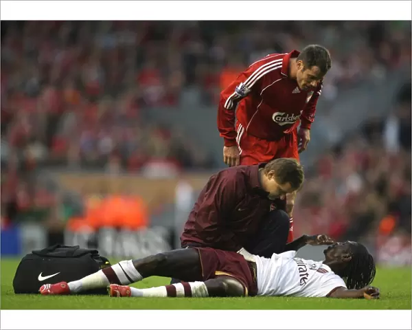 Injured Emmanuel Adebayor is treated by Arsenal physio Gary Lewin