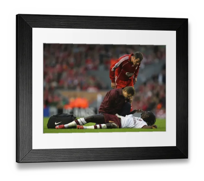 Framed Print : Injured Emmanuel Adebayor is treated by Arsenal physio Gary Lewin Framed Print : Injured Emmanuel Adebayor is treated by Arsenal physio Gary Lewin