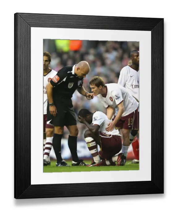 Framed Print : Injured Emmanuel Eboue is helped by Arsenal team mate Alex Hleb