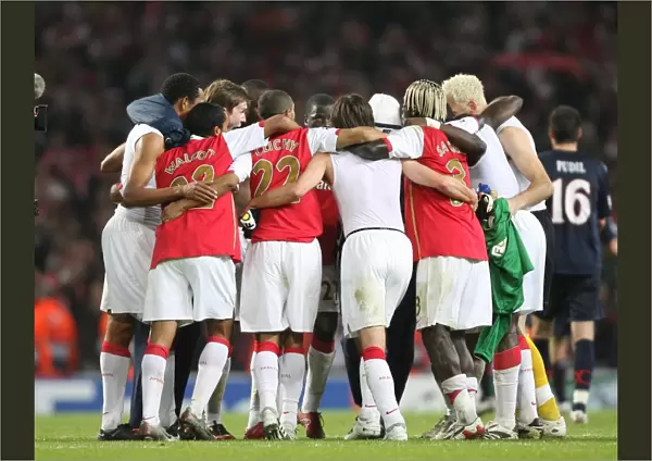 Arsenal players form a huddle at the end of the match
