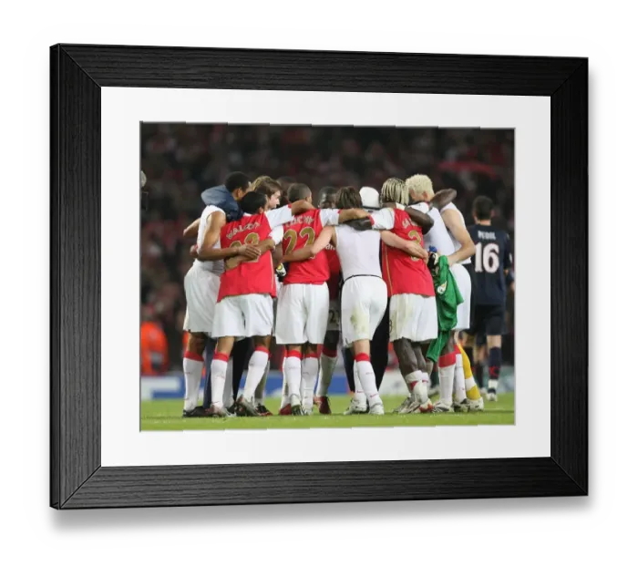 Framed Print : Arsenal players form a huddle at the end of the match