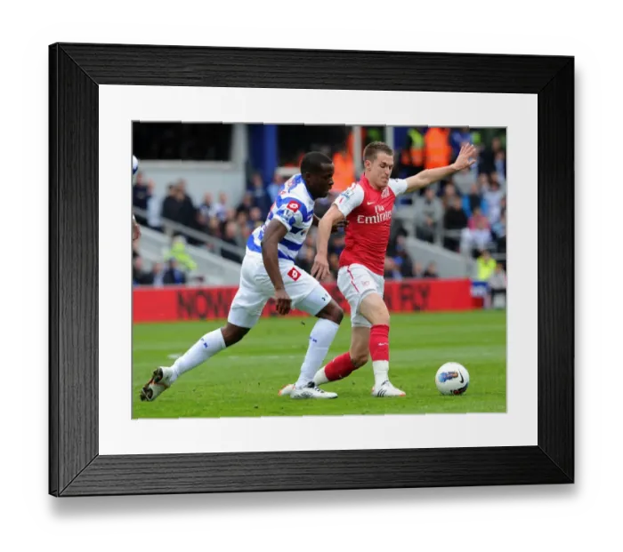 Framed Print : Arsenal's Aaron Ramsey Faces Off Against Nedum Onuoha in Intense Queens Park Rangers Clash