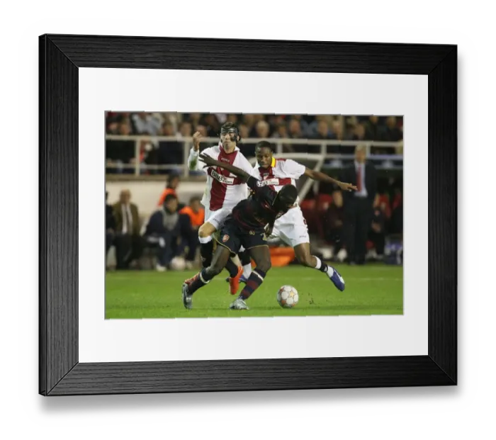 Framed Print : Champions League Showdown: Seville's Triumph over Arsenal - Eboue vs. Crespo & Fazio (November 2007)
