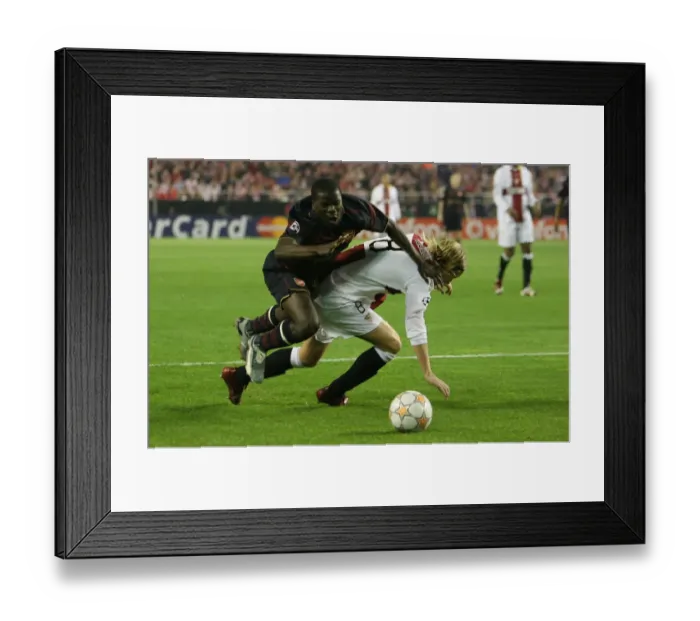 Framed Print : Emmanuel Eboue (Arsenal) Christian Poulsen (Seville) Framed Print : Emmanuel Eboue (Arsenal) Christian Poulsen (Seville)