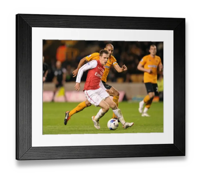 Framed Print : Arsenal's Aaron Ramsey Outsmarts Carl Henry: Premier League Showdown between Arsenal and Wolverhampton Wanderers (2012) Framed Print : Arsenal's Aaron Ramsey Outsmarts Carl Henry: Premier League Showdown between Arsenal and Wolverhampton Wanderers (2012)