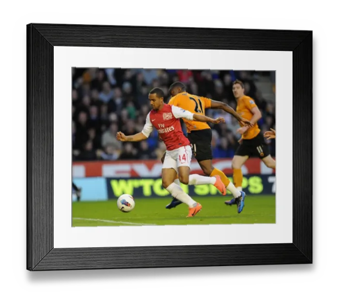 Framed Print : Theo Walcott vs Sebastien Bassong: A Penalty Showdown at Molineux (2011-12) Framed Print : Theo Walcott vs Sebastien Bassong: A Penalty Showdown at Molineux (2011-12)