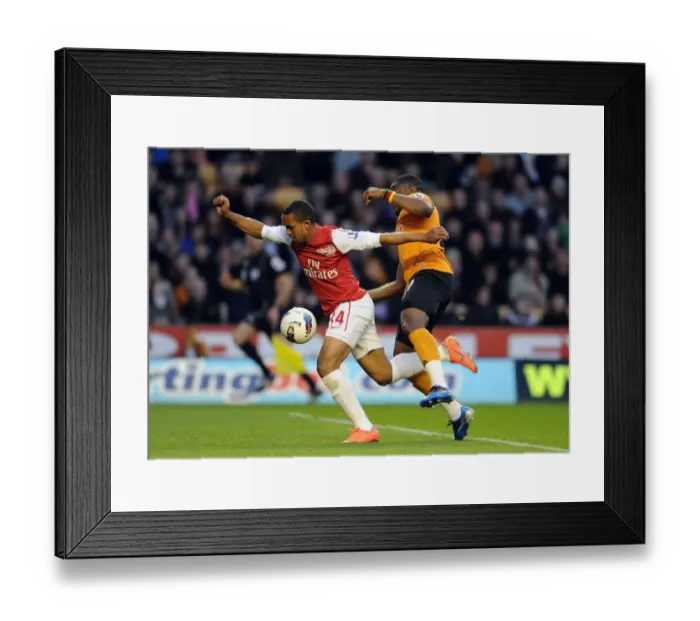 Framed Print : Theo Walcott vs. Sebastien Bassong: A Penalty Showdown Deciding Arsenal's Victory (2011-12) Framed Print : Theo Walcott vs. Sebastien Bassong: A Penalty Showdown Deciding Arsenal's Victory (2011-12)