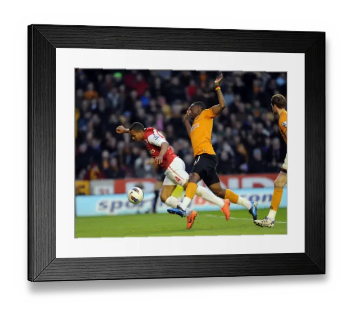 Framed Print : Theo Walcott vs Sebastien Bassong: A Penalty Showdown at Molineux (2011-12) Framed Print : Theo Walcott vs Sebastien Bassong: A Penalty Showdown at Molineux (2011-12)