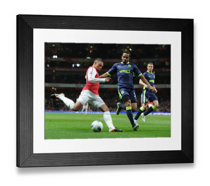 Framed Print : Arsenal's Alex Oxlade-Chamberlain Clashes with Wigan's Jean Beausejour during the Premier League Match