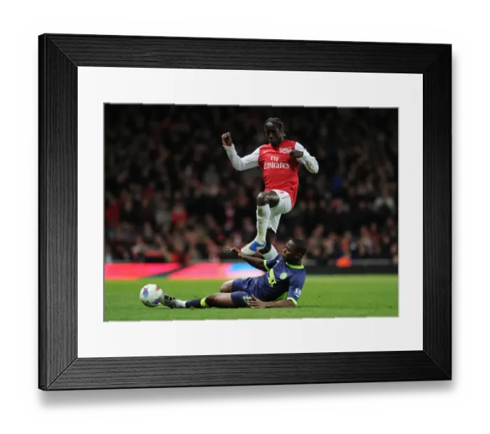 Framed Print : Arsenal's Bacary Sagna Jumps Over Wigan's Figueroa during the 2011-12 Premier League Match