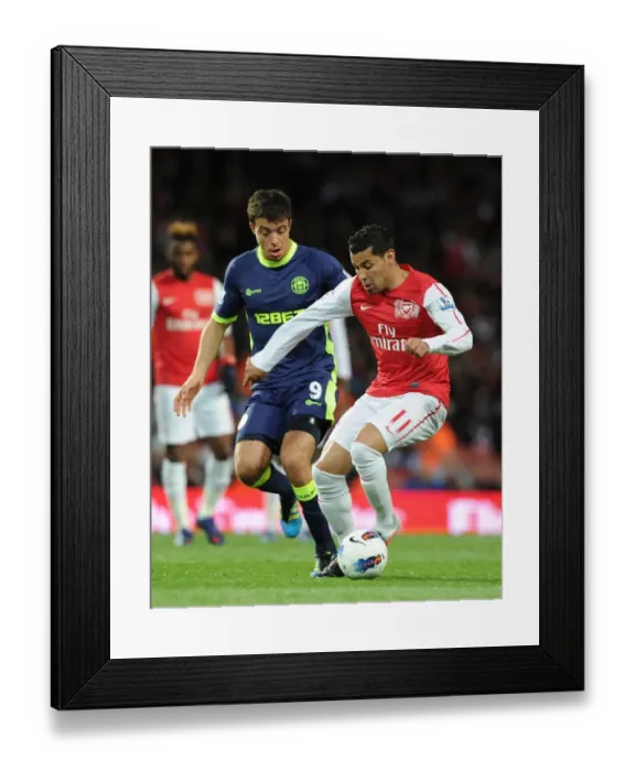 Framed Print : Clash of Santos: Arsenal's Andre Faces Wigan's Franco in Premier League Showdown