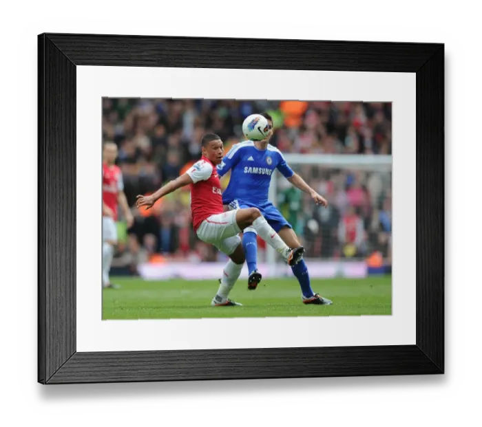 Framed Print : Arsenal's Oxlade-Chamberlain Clashes with Chelsea's Romeu: A Premier League Showdown at Emirates Stadium Framed Print : Arsenal's Oxlade-Chamberlain Clashes with Chelsea's Romeu: A Premier League Showdown at Emirates Stadium