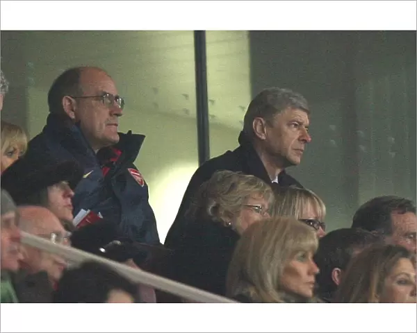 Arsenal manager Arsene Wenger and 1st team Coach watch the match from the Directors box