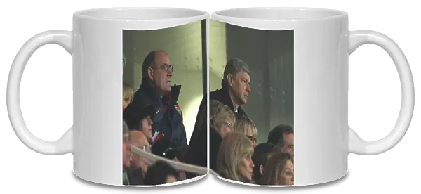 Arsenal manager Arsene Wenger and 1st team Coach watch the match from the Directors box