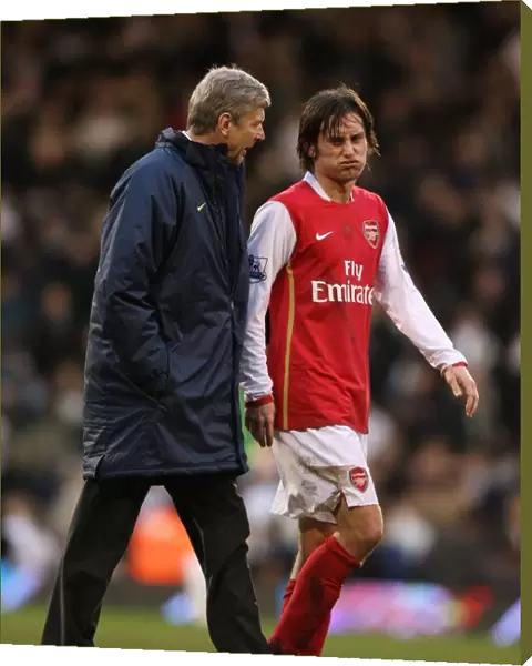 Arsenal manager Arsene Wenger talks with Tomas Rosicky at half time