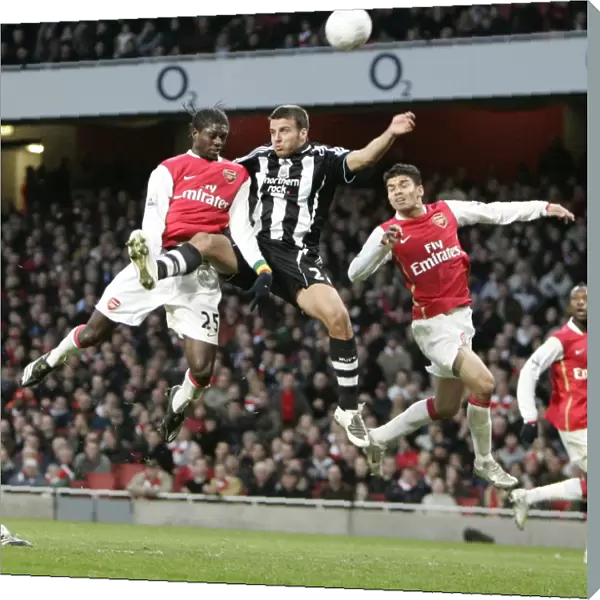Emmanuel Adebayor and Eduardo (Arsenal) jump with Steven Taylor (Newcastle)