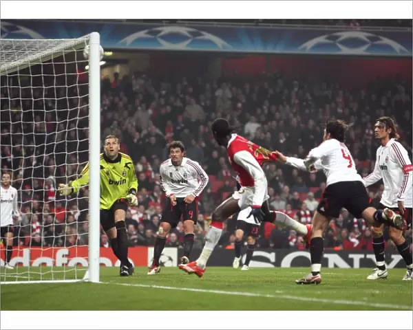 Emmanuel Adebayors header hits the crossbar as AC Milan goalkeeper Zeljko Kalac looks on