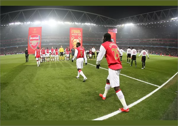 The Arsenal team walk onto the pitch before the match