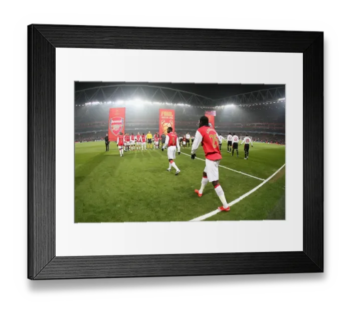 Framed Print : The Arsenal team walk onto the pitch before the match
