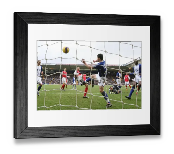 Framed Print : Theo Walcott shoots past Damien Johnson to score the 1st Arsenal goal Framed Print : Theo Walcott shoots past Damien Johnson to score the 1st Arsenal goal