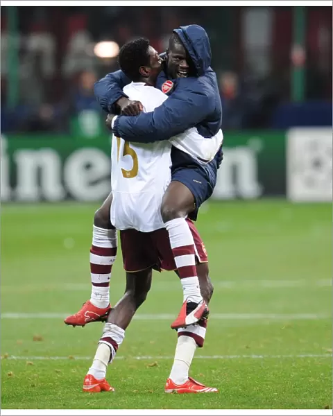 Emmanuel Adebayor and Emmanuel Eboue celebrate Arsenals victory