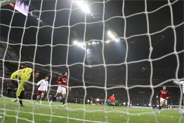 Emmanuel Adebayor shoots past AC Milan goalkeeper Zelijo Kalac to score the 2nd Arsenal goal