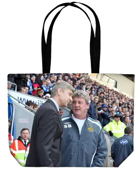 Arsene Wenger the Arsenal Manager speaks to Steve Bruce the Wigan Manager before the match