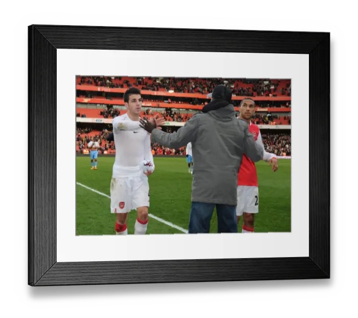Framed Print : Suspended Emmanuel Eboue congratulates Cesc Fabregas and Gael Clichy after the match