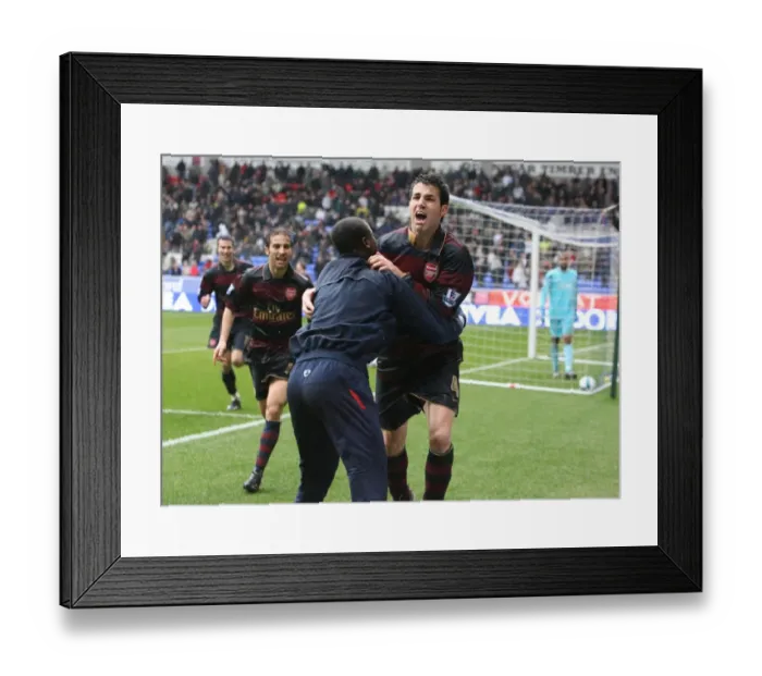 Framed Print : Cesc Fabregas Triumphant Goal: Arsenal's 3-2 Victory Over Bolton Wanderers (Fabregas, Eboue, Flamini)