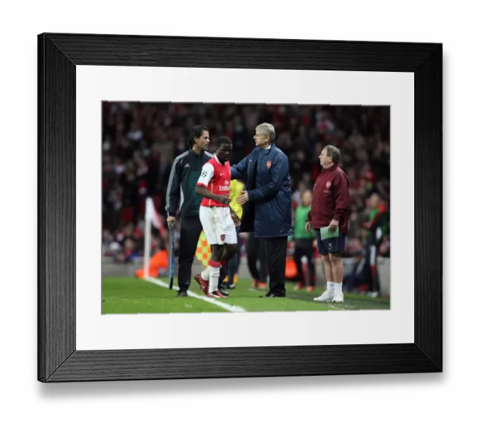 Framed Print : Arsenal manager Arsene Wenger pats Emmanuel Eboue on the back after his substitution
