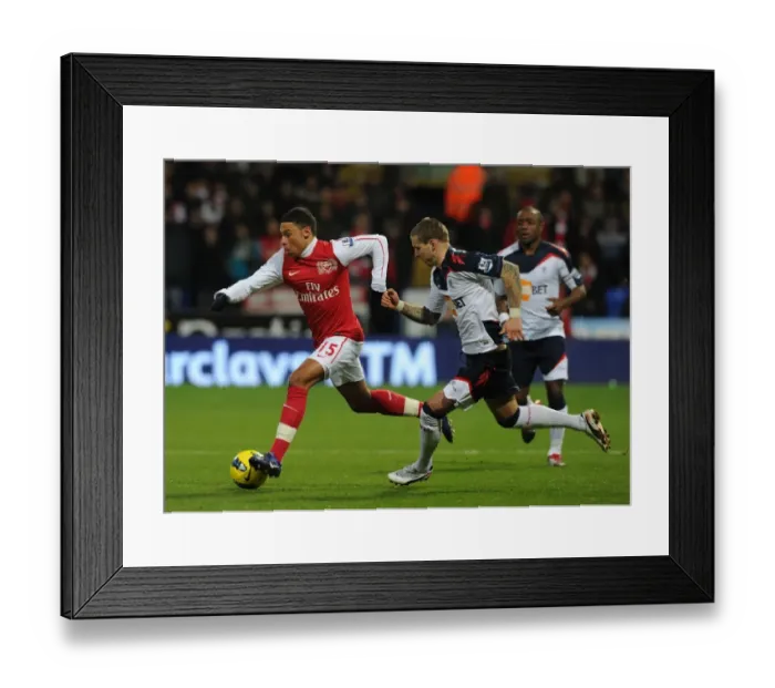 Framed Print : Alex Oxlade-Chamberlain Surges Past Gretar Steinsson in Bolton vs Arsenal Premier League Clash Framed Print : Alex Oxlade-Chamberlain Surges Past Gretar Steinsson in Bolton vs Arsenal Premier League Clash