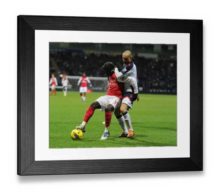 Framed Print : Bacary Sagna vs. Martin Petrov: Shielding the Ball in the Premier League Clash between Bolton Wanderers and Arsenal