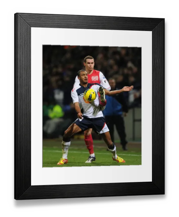 Framed Print : Thomas Vermaelen vs. David Ngog: Intense Tackle at Bolton Wanderers vs. Arsenal (2011-12)