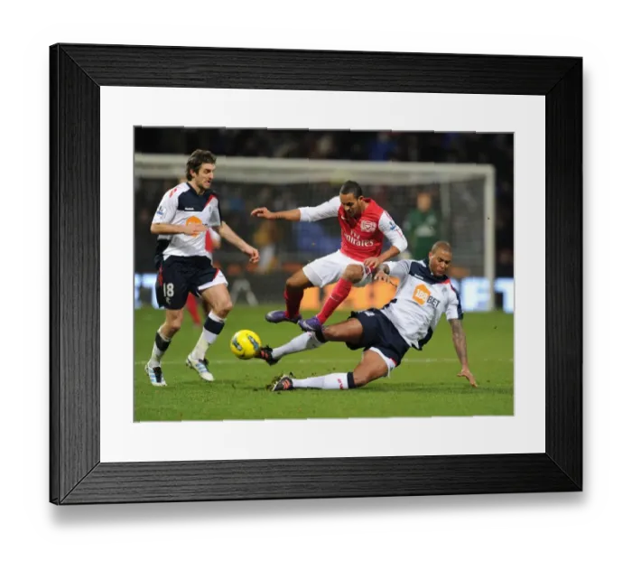 Framed Print : Theo Walcott vs Zat Knight: Intense Battle at Bolton Wanderers vs Arsenal (2011-12)