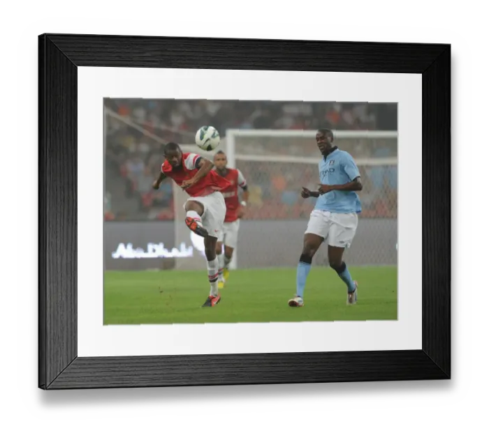 Framed Print : Arsenal's Abou Diaby Battles Past Yaya Toure in Arsenal FC vs Manchester City Pre-Season Clash in Beijing, 2012